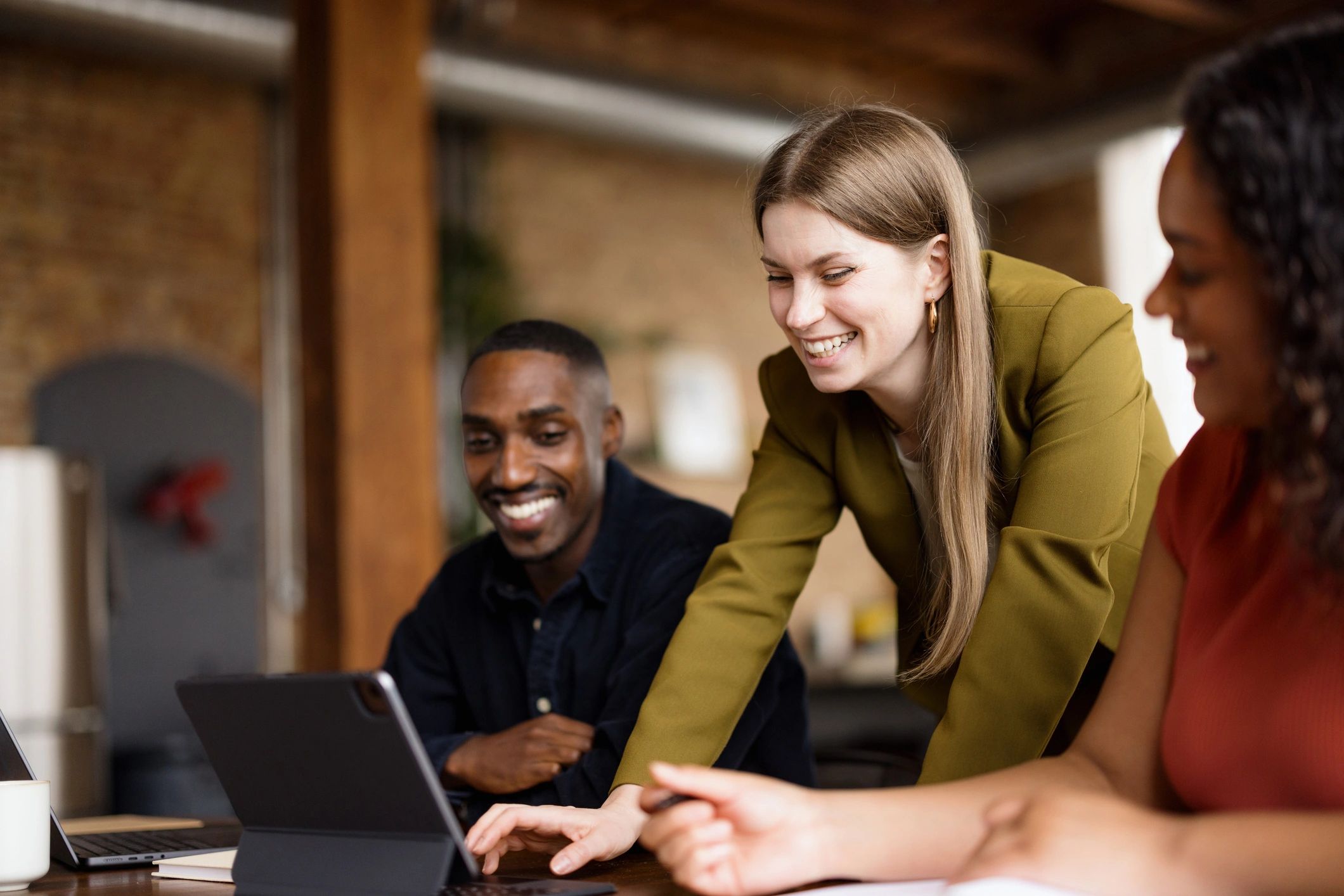 Team collaborating around a tablet in a modern office